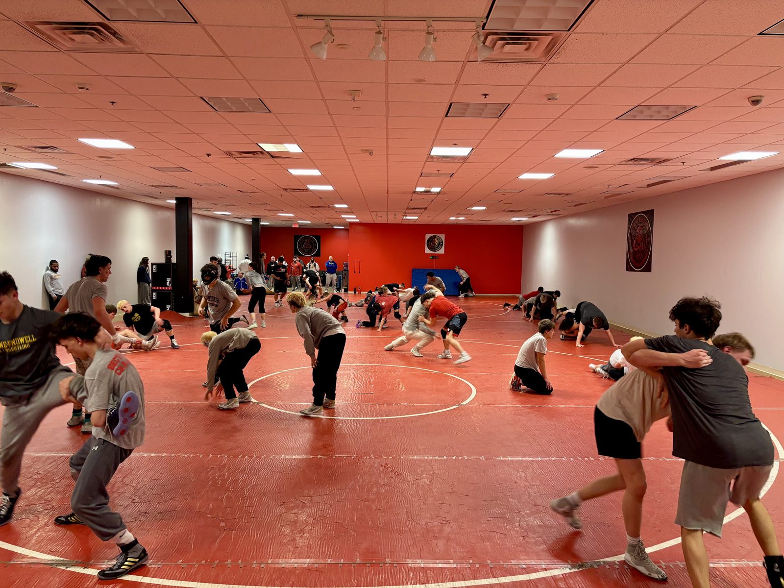 Frog Empire Wrestling Academy training room filled with athletes
