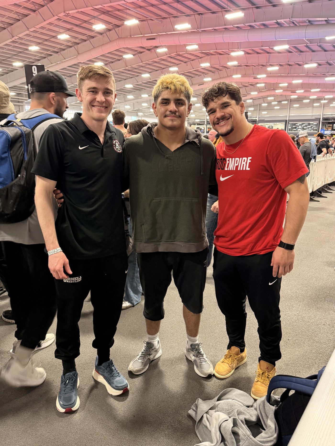 Julian Ramirez with athletes at a wrestling event